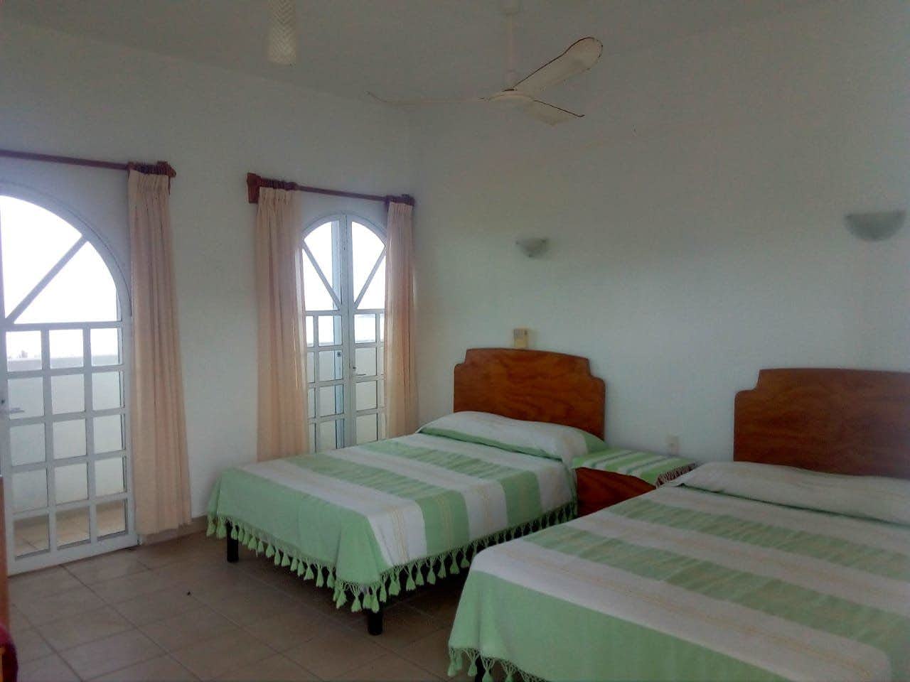 Room with 2 double beds and a balcony