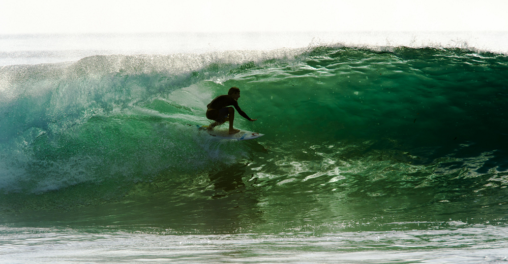 Surfing a beautiful green wave in the Galapagos