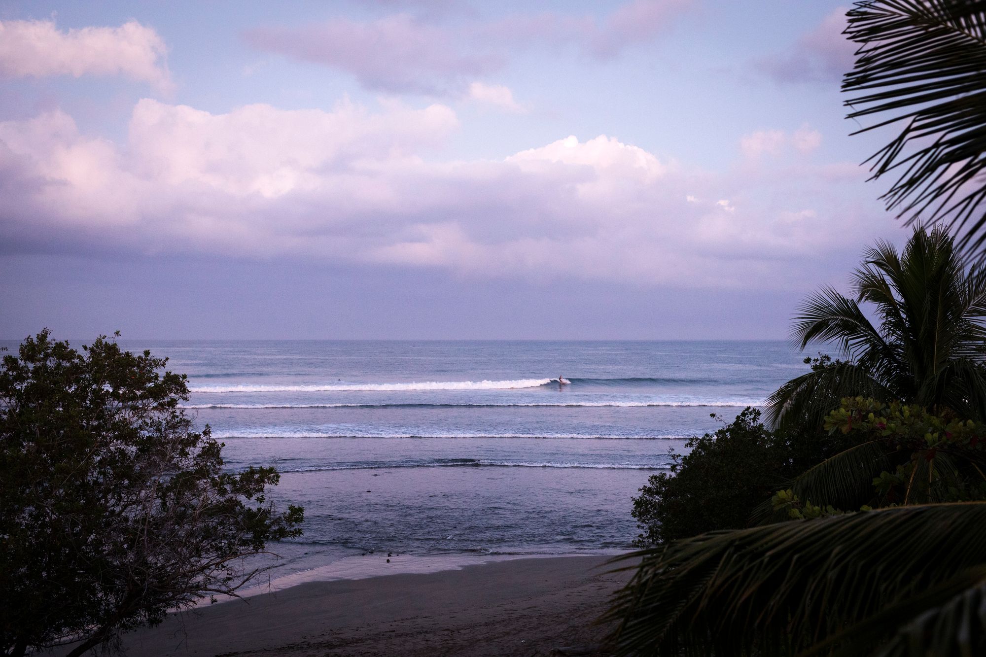 surfer on a long left pointbreak in La Saladita, one of the best surf towns in Mexico