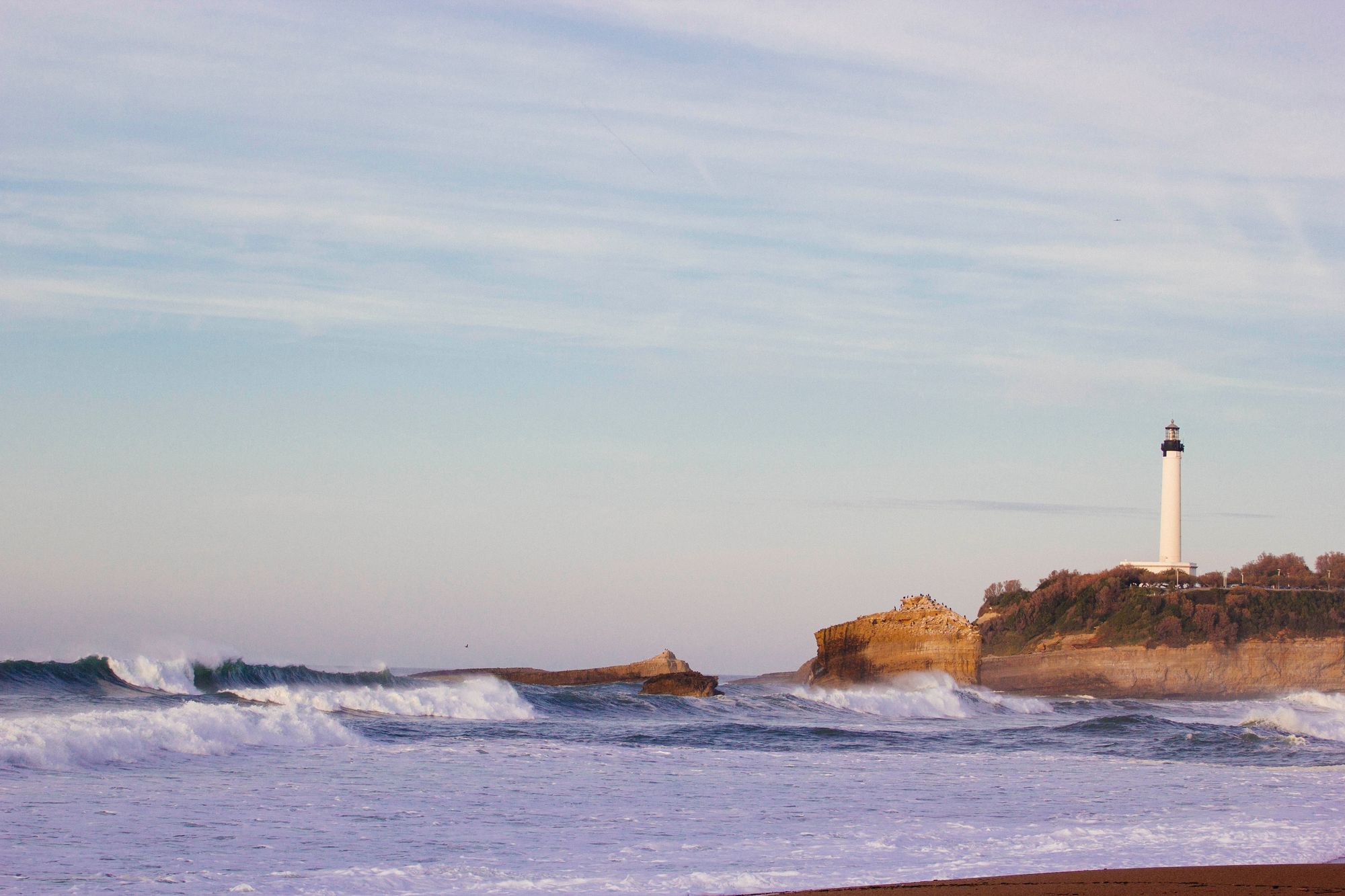 Waves in front of the lighthouse in Biarritz, France