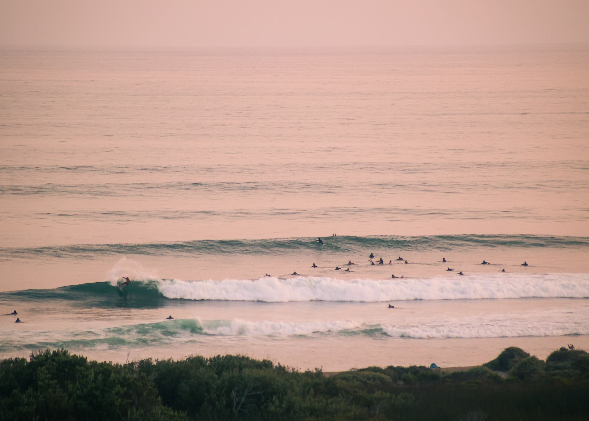 Jake Davis surfing the Southern California surf spot Trestles at Sunset