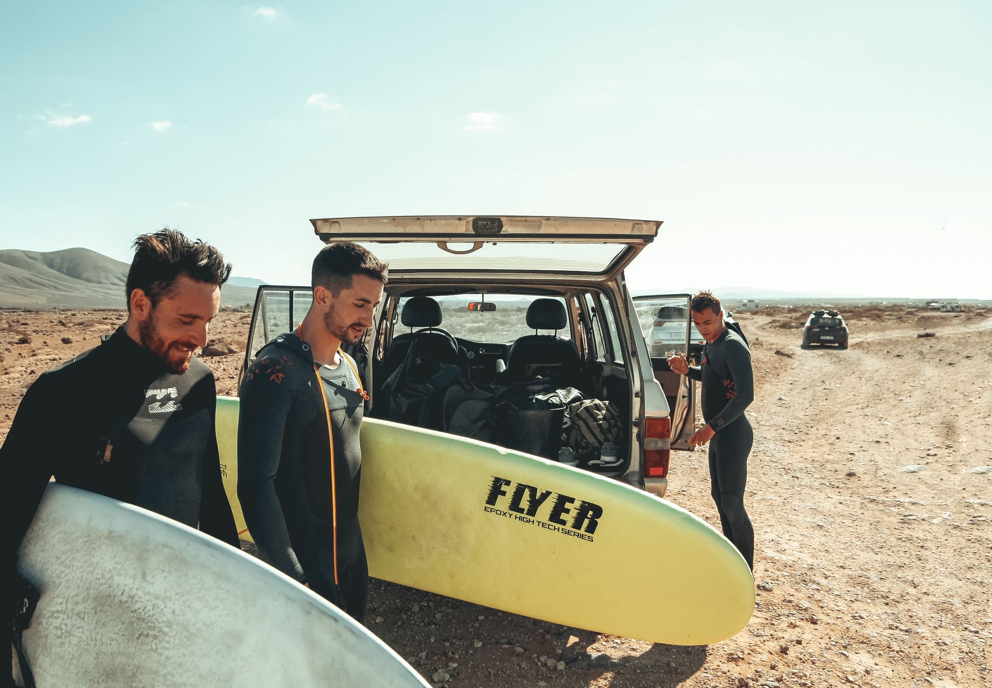 surfers traveling with surfboards