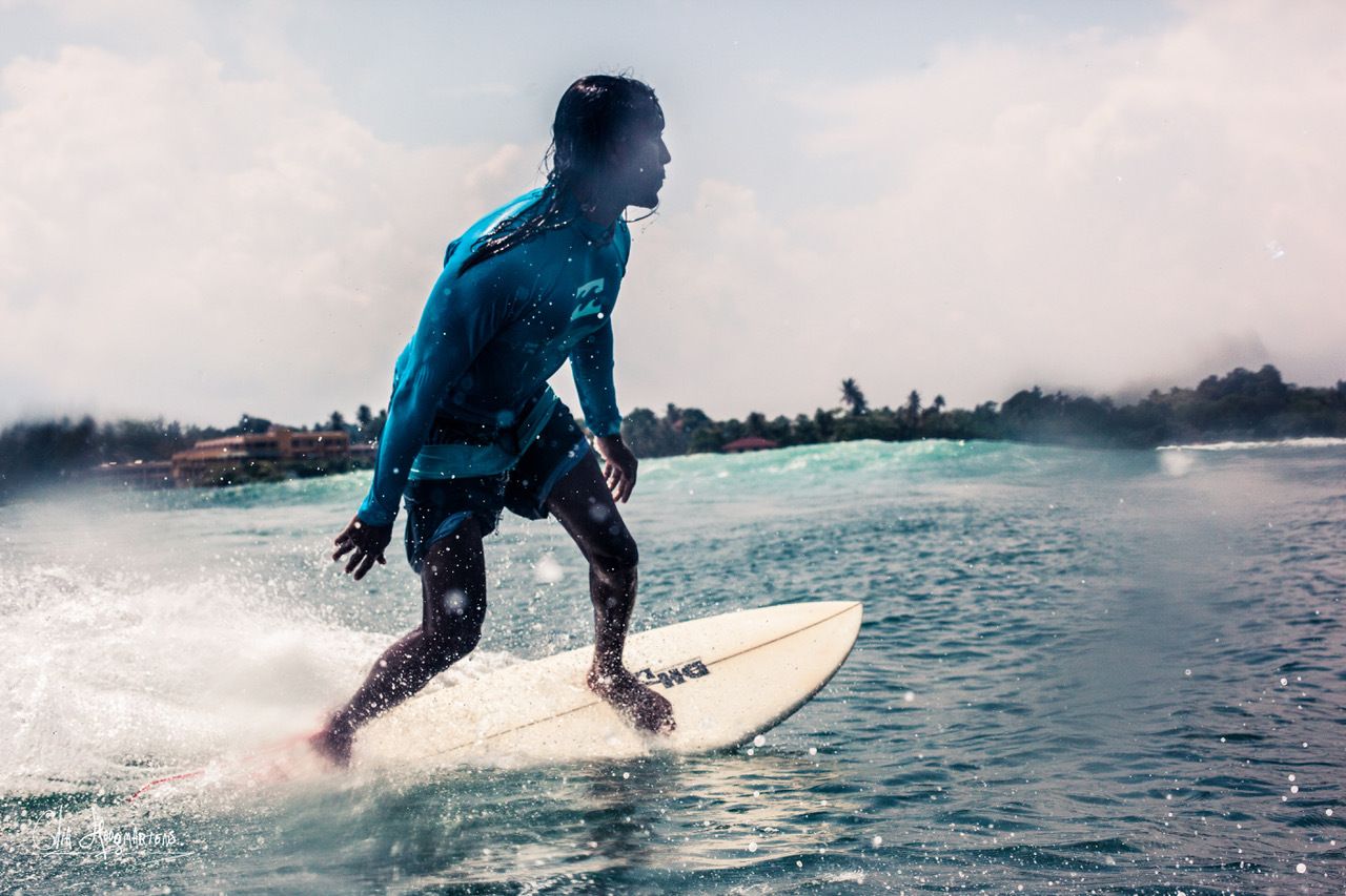 Lahiru, owner of The Surfer Weligama, surfing on the Sri Lankan coastline