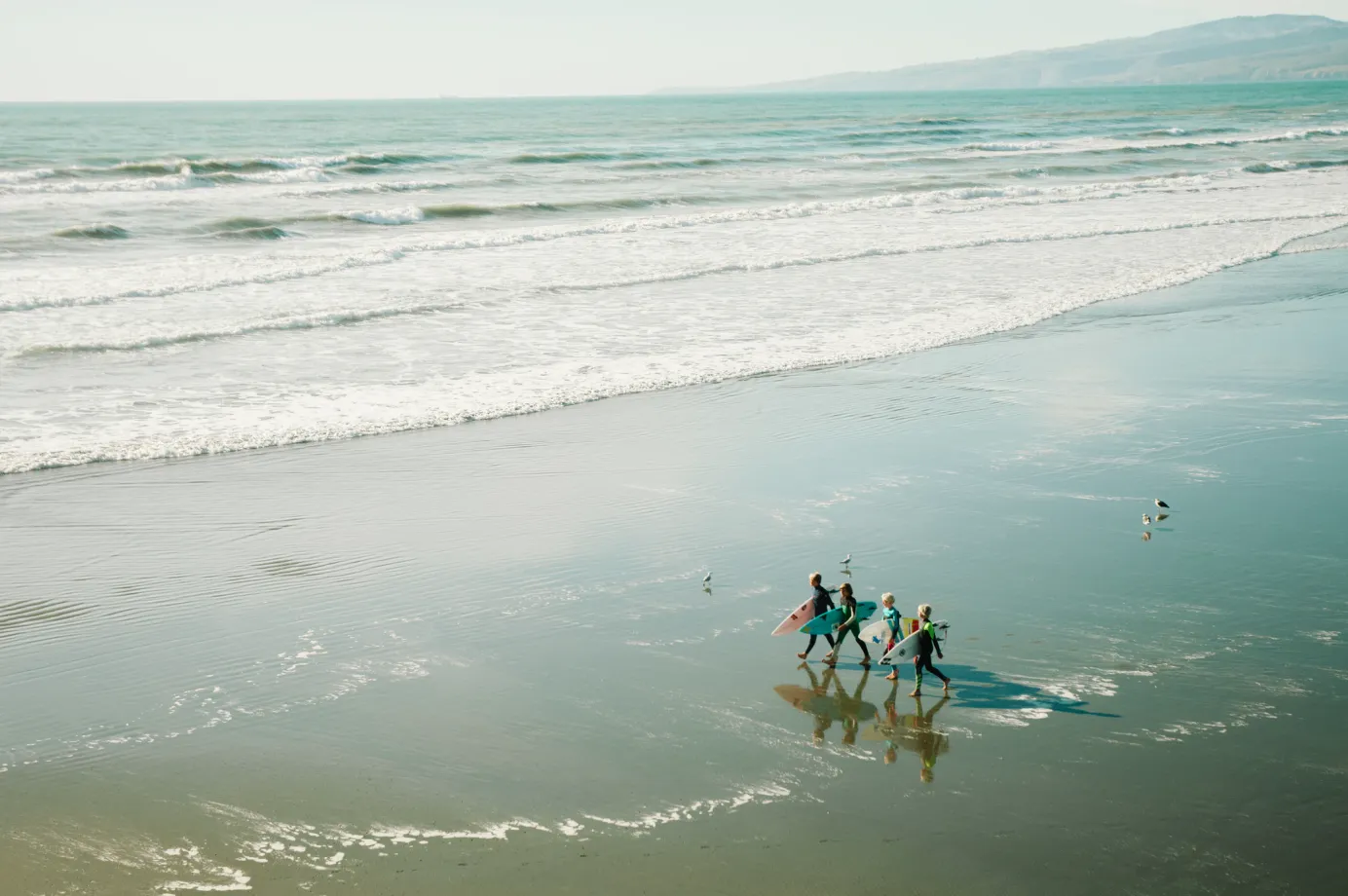 A group of kids on a family surf trip at the beach